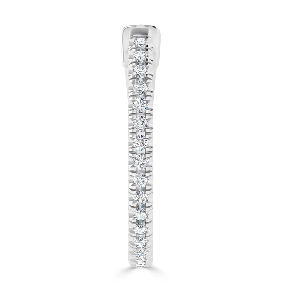 A silver ring with a row of small round diamonds set along the top, viewed from the side.