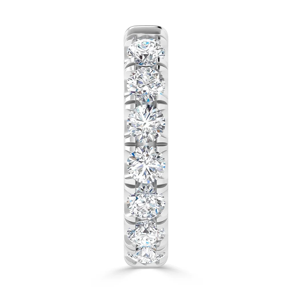 A white gold ring with a vertical row of seven round, sparkling diamonds set in a channel setting.