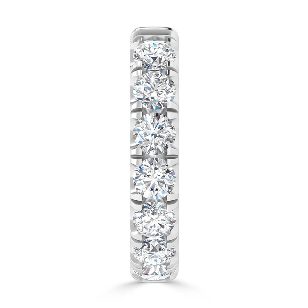 A white gold ring set with seven round white diamonds in a vertical row, shown from the front.