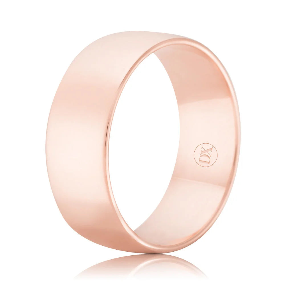 A plain, wide rose gold ring with a polished finish and a small engraved logo on the inner band.