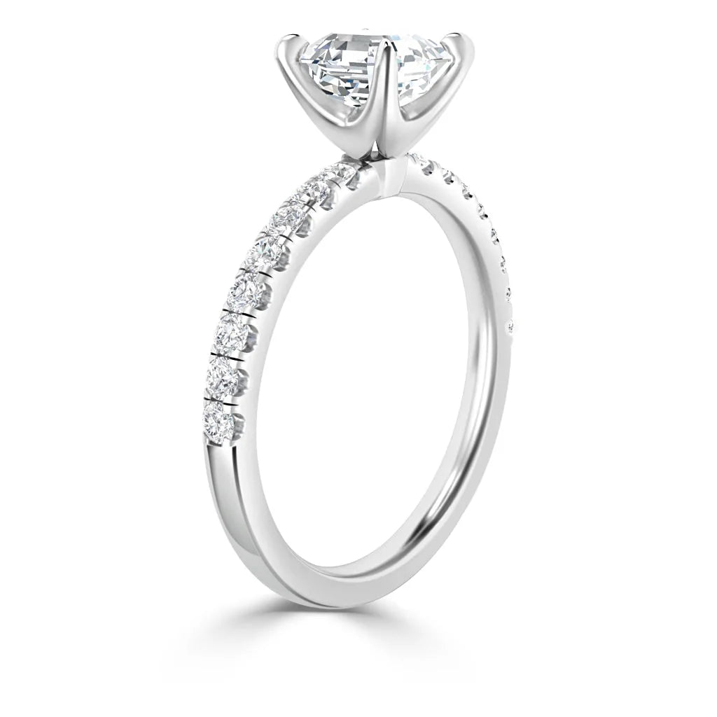 White gold ring with a large solitaire diamond and smaller diamonds set along the band, viewed from the side.