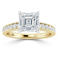 Gold ring with an Asscher-cut diamond center and round diamonds along the band, seen from the front.