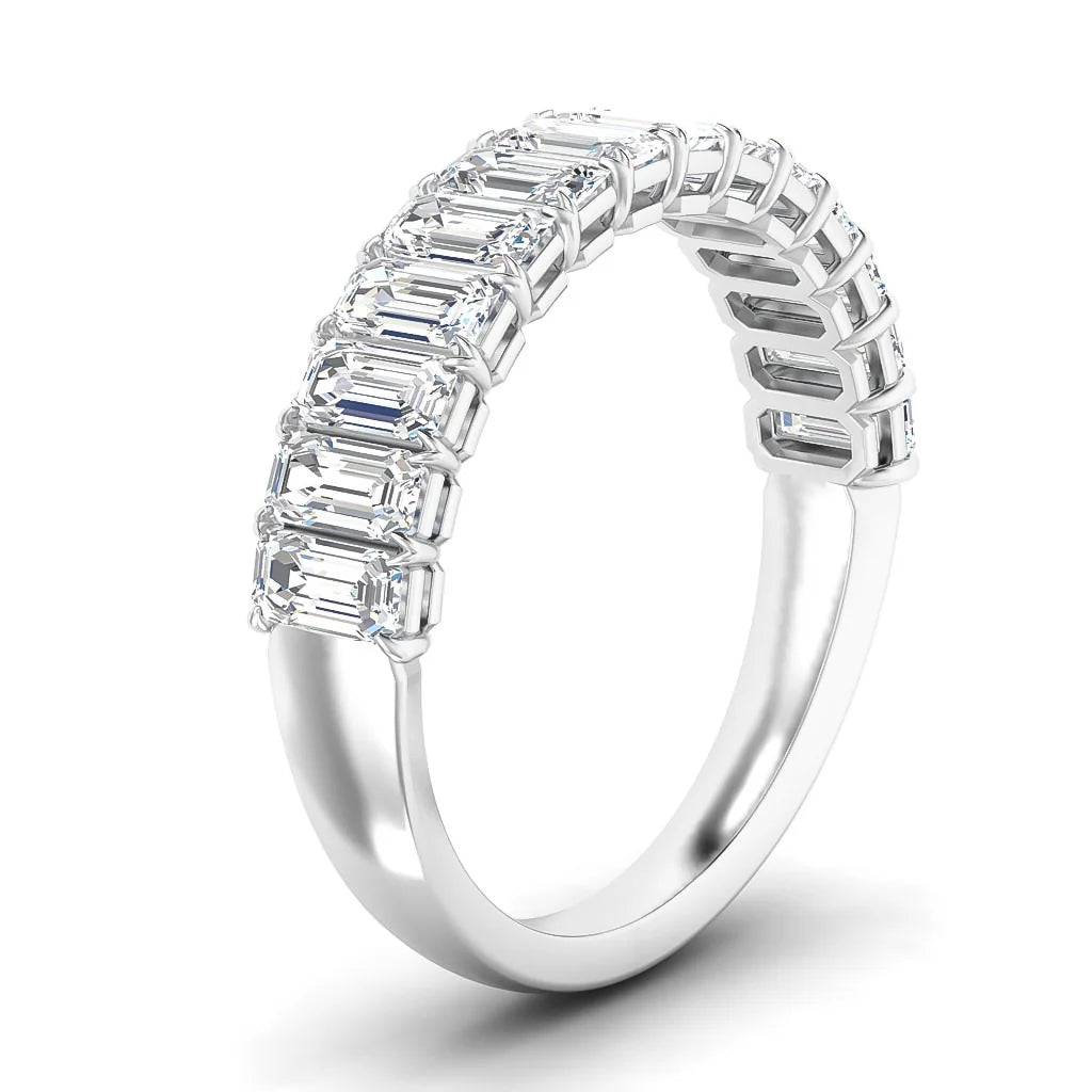White gold ring with a row of rectangular emerald-cut diamonds set across the top in a modern style.