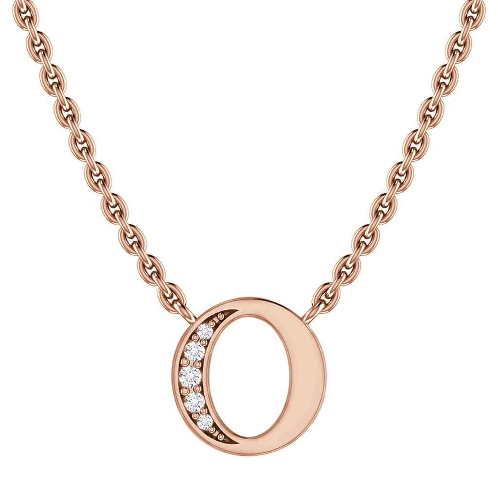 Rose gold chain necklace with circular pendant; left side of circle is set with seven small white gemstones.