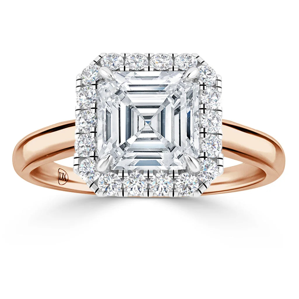 A rose gold ring with a large square diamond center, surrounded by two halos of small round diamonds.