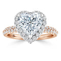 Heart-shaped diamond ring with a halo setting, pavé band, and rose gold shank.