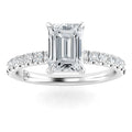 Emerald-cut diamond ring with a pavé band set in white gold, viewed from the front on a white background.