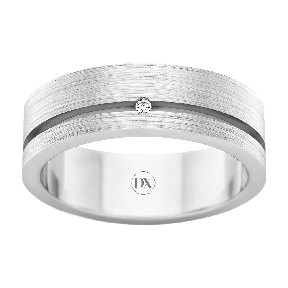 Silver band ring with a brushed finish, a single small diamond, and an engraved “DX” inside.