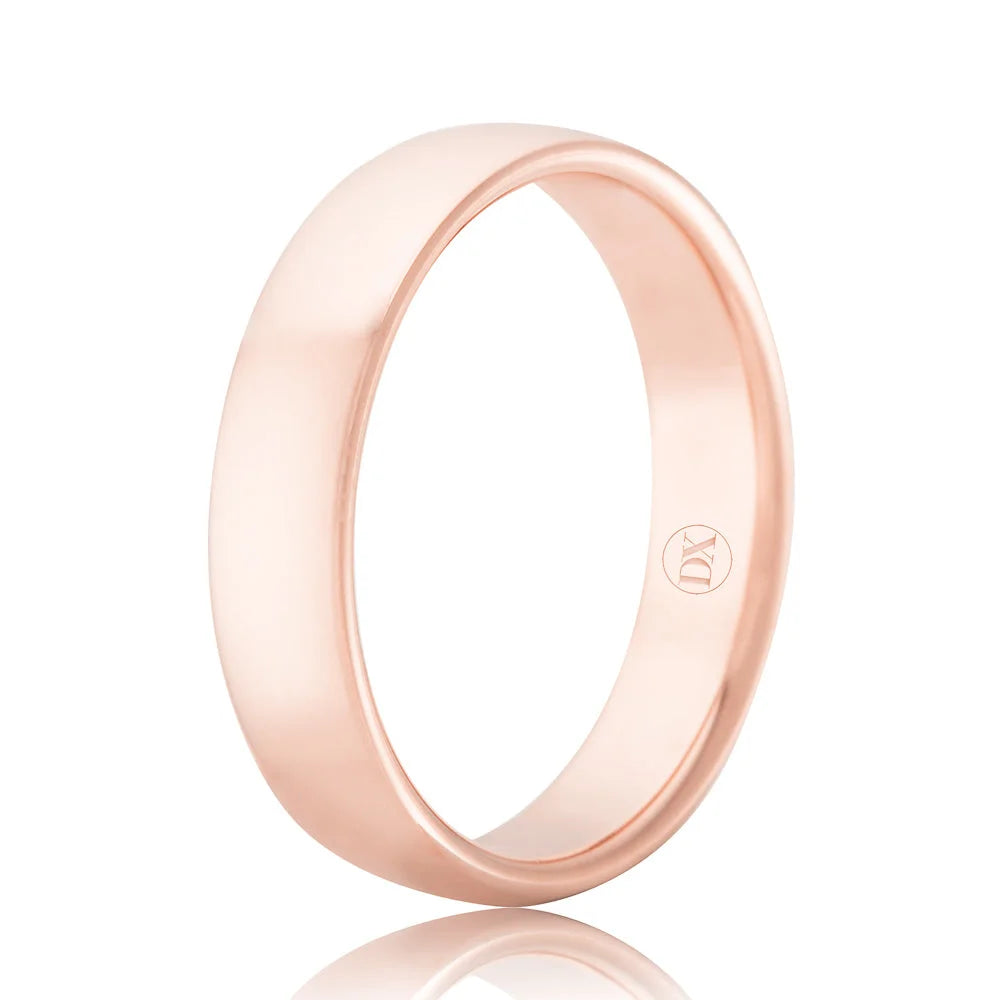 A plain, polished rose gold band ring with a small engraved logo inside, displayed on a white background.