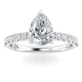 A pear-shaped diamond ring with a diamond-studded band on a plain white background.