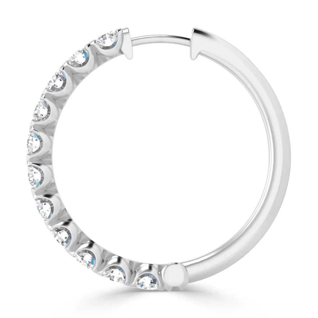 A silver hoop earring adorned with small round diamonds along half of its outer edge.