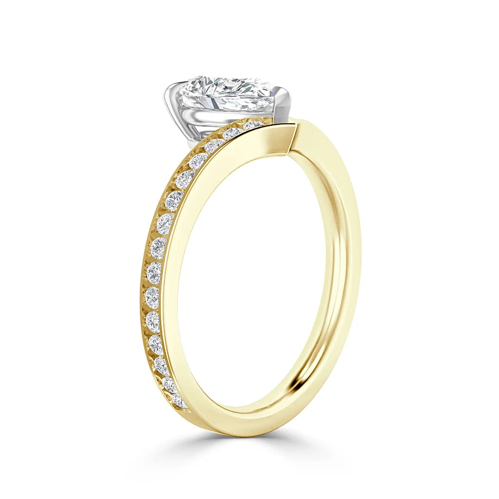 A gold ring with small diamonds on the band and a large solitaire diamond in a silver prong setting.