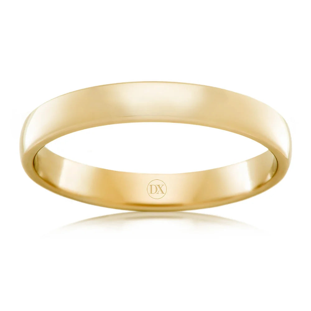 A simple, polished yellow gold ring with a smooth surface and a small DX engraving inside.