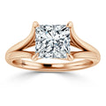 Rose gold ring with split shank band and large square-cut diamond in a four-prong setting.