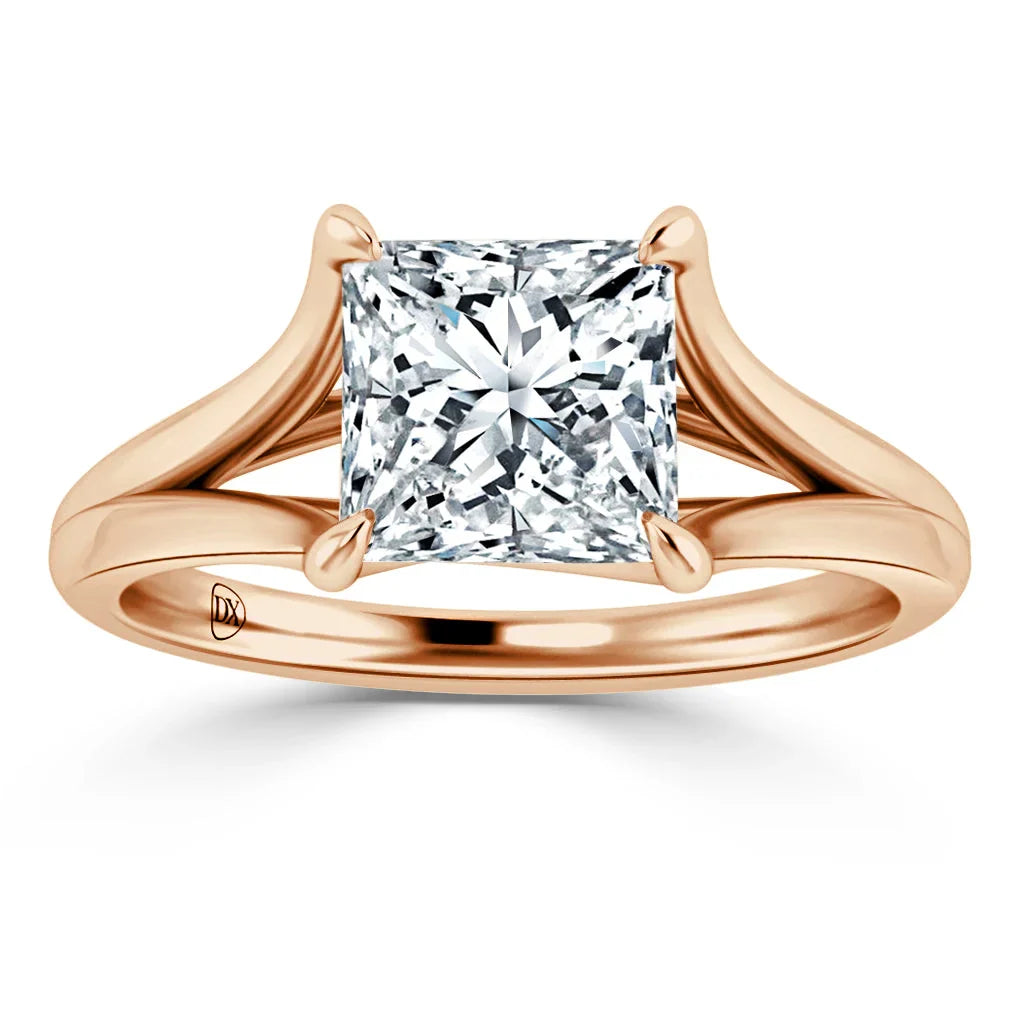 Rose gold ring with split shank band and large square-cut diamond in a four-prong setting.