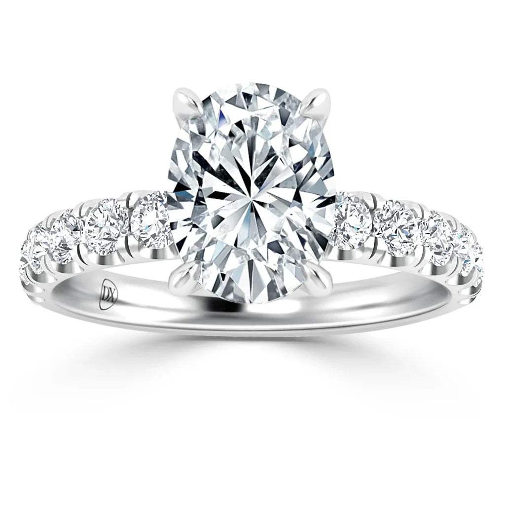 Oval-cut diamond ring with side diamonds on a silver band, shown from the front on a white background.