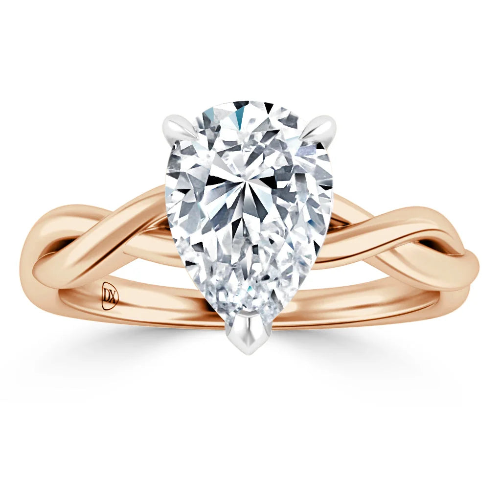 A pear-shaped diamond ring with a twisted rose gold band on a white background.