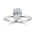 A silver ring with a large oval-cut diamond in a four-prong solitaire setting on a plain band.
