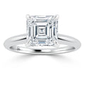 A silver ring featuring a large, square-cut diamond in a four-prong solitaire setting, shown on a white background.