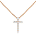 Gold chain necklace with a cross pendant made of round, sparkling diamonds on a white background.