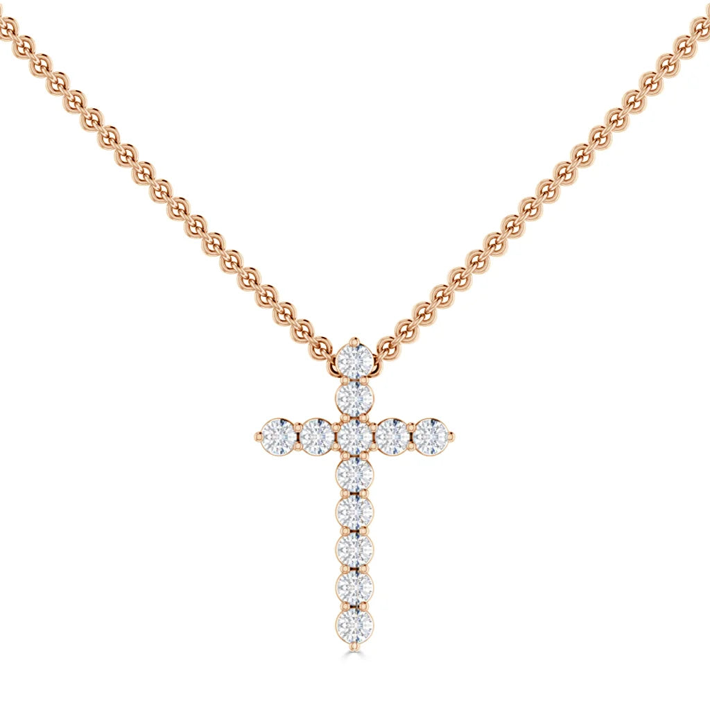 Gold chain necklace with a cross pendant made of round, sparkling diamonds on a white background.