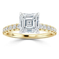 Gold ring with an Asscher-cut diamond center and small round diamonds set along the band.