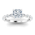 A cushion-cut diamond ring with a twisted band set with marquise and round accent diamonds in white gold.