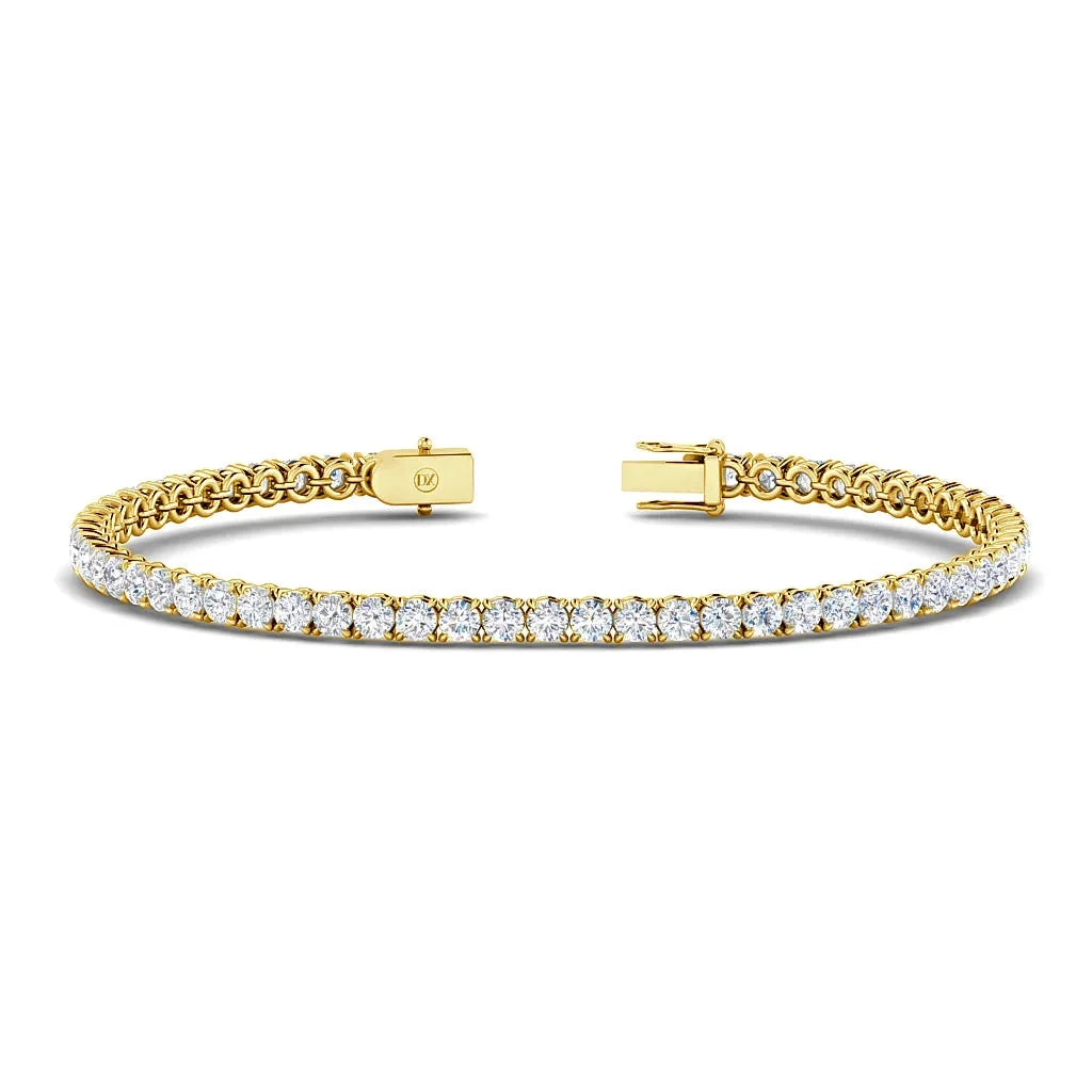 A gold tennis bracelet with a row of round white diamonds and a clasp, displayed on a white background.