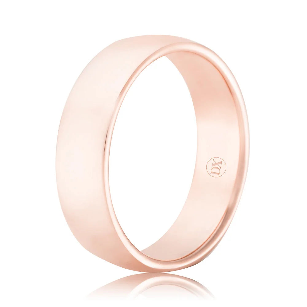 A plain, polished rose gold wedding band with a smooth finish and a subtle logo engraved inside.