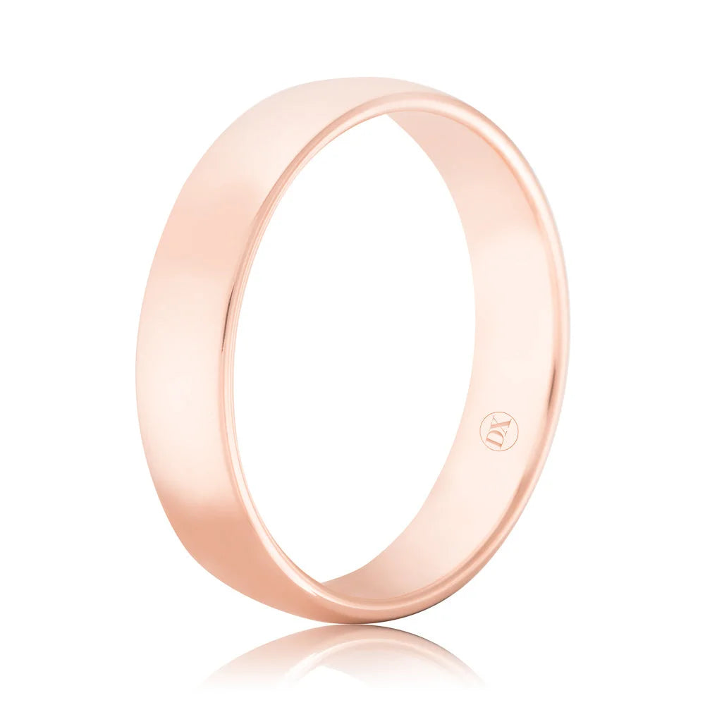 Simple rose gold wedding band with a smooth, polished finish and a small engraved logo on the inside.