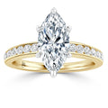 Marquise-cut diamond ring with a yellow gold band, featuring small diamonds along the band’s upper side.