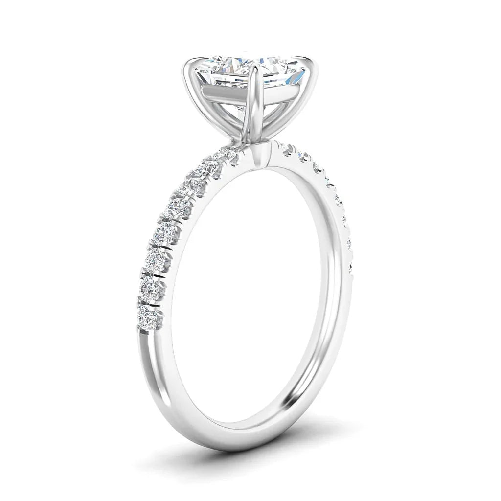 A white gold ring with a round solitaire diamond and small diamonds set along the band.