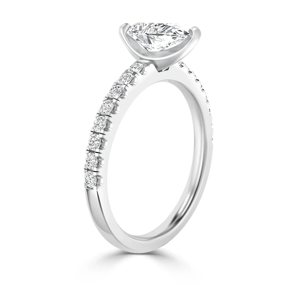A white gold ring with a marquise diamond center stone and small diamonds along the band.