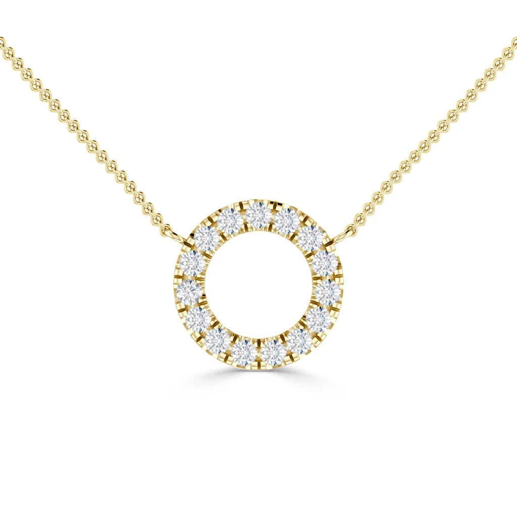 Gold chain necklace with a circular pendant encrusted with small sparkling diamonds on a white background.