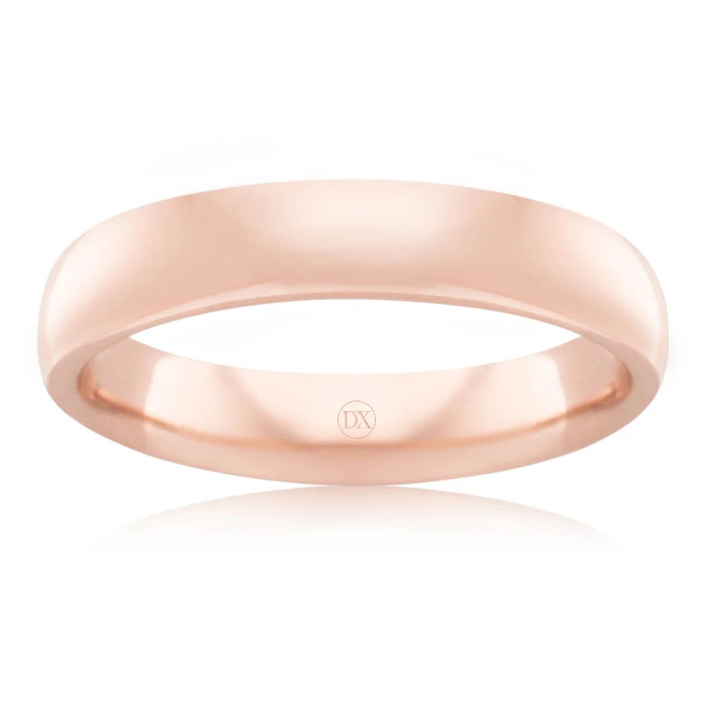 Simple rose gold wedding band with a smooth, polished finish and a subtle “DX” engraving inside the band.