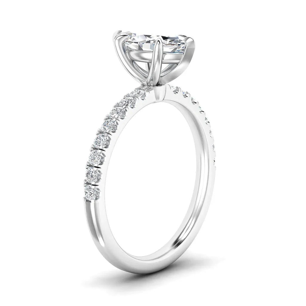 A white gold ring with a large round solitaire diamond and smaller diamonds on the upper half of the band.