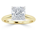 Gold band ring with a large square-cut diamond in a four-prong white gold setting, shown on a white background.