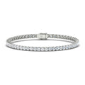 A silver tennis bracelet with round, sparkling white diamonds set in a single row, lying flat on a white background.
