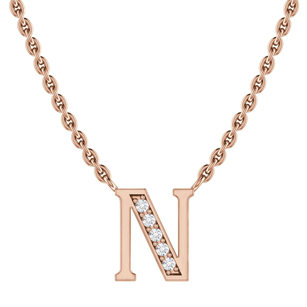 Rose gold chain necklace with a letter N pendant, partly adorned with small sparkling diamonds.