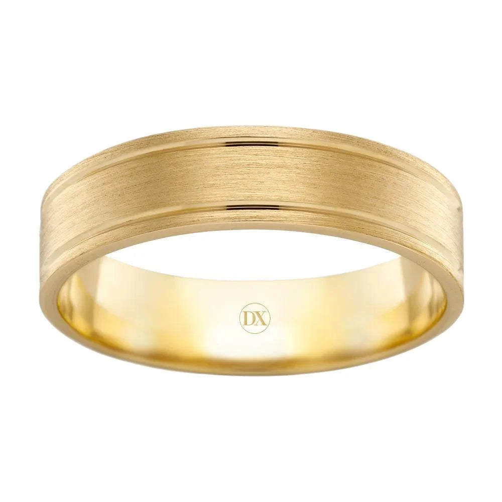 A simple, brushed gold wedding band with a smooth edge and a small “DX” logo inside the band.