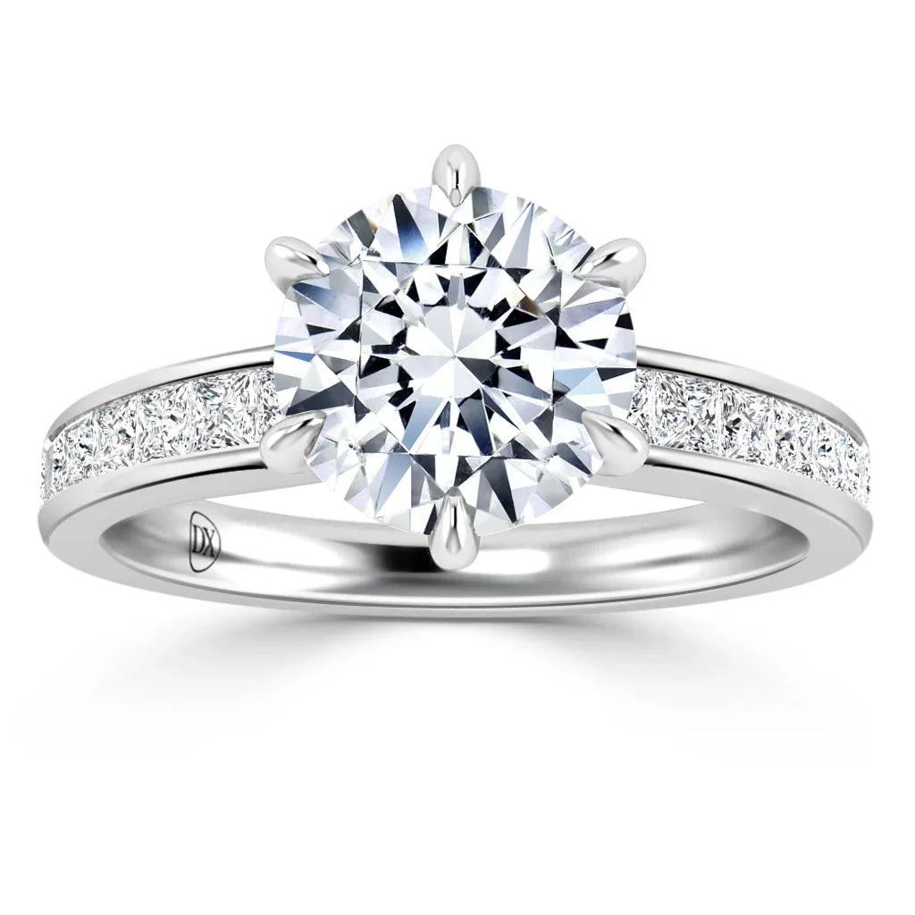 Platinum ring with a large round diamond center stone and smaller diamonds set along the band.
