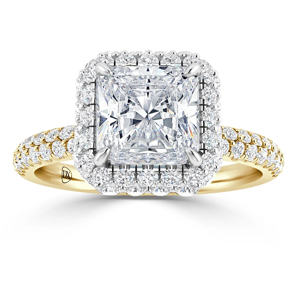 A gold ring with a large square diamond center, double halo of smaller diamonds, and a diamond-studded band.