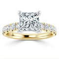 Gold ring with a large princess-cut diamond center and smaller round diamonds along the band.