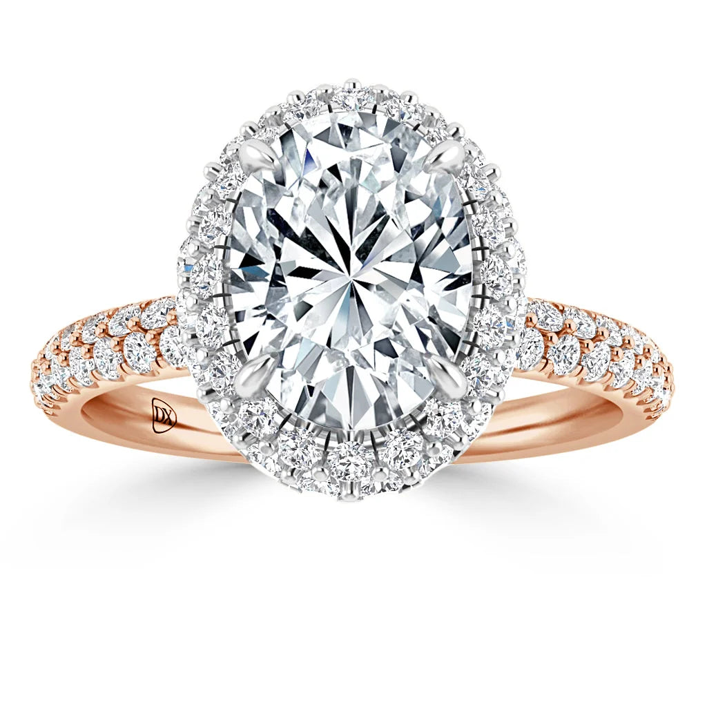Rose gold ring with large oval diamond center, surrounded by a halo of small diamonds on a diamond-studded band.