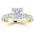Gold ring with a large square-cut diamond center and smaller round diamonds along the band.