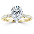 A pear-shaped diamond ring with a yellow gold band, set with small round diamonds along the band.