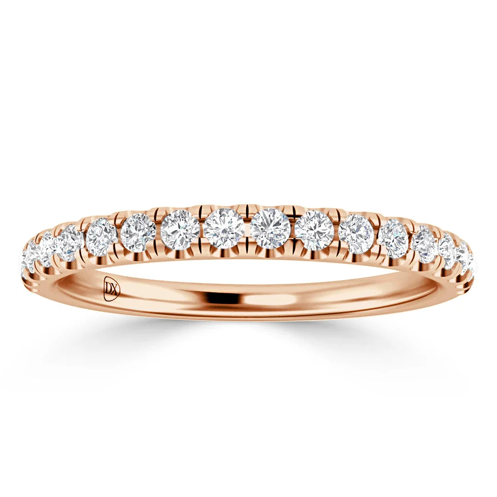 A rose gold ring with a row of round white diamonds set along the band in a pavé style.