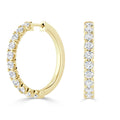 Gold hoop earrings with round white diamonds set along the front and outer edges, shown from side and front views.