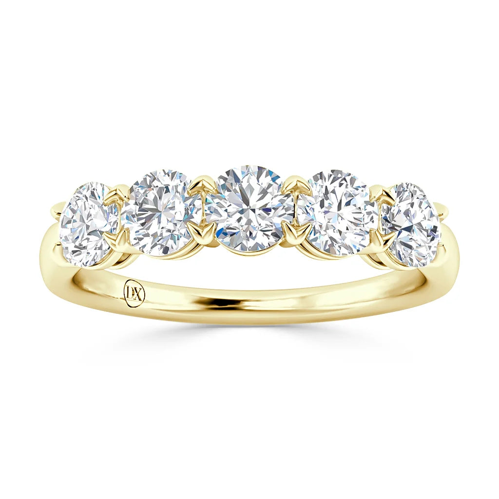 A gold ring with five round, sparkling diamonds set in a row along the top of the band.