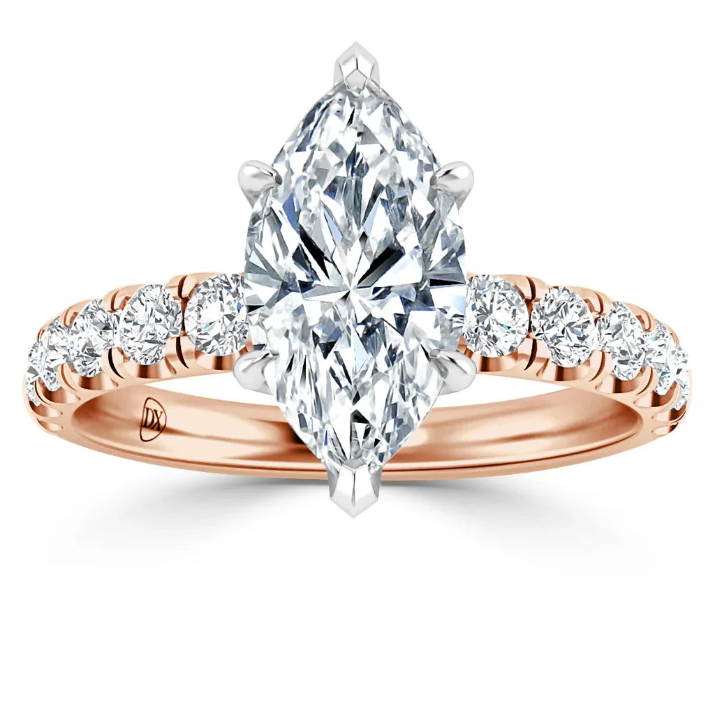 Rose gold ring with a large marquise-cut diamond and smaller round diamonds on the band, shown on white background.